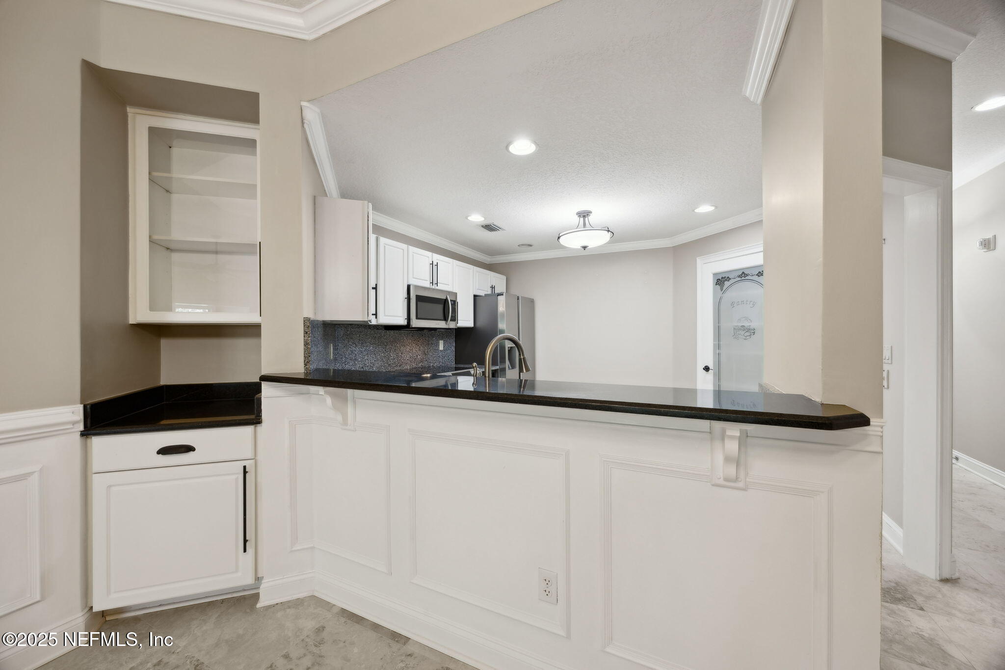 300 Bermuda Bay Circle, Unit 304 Ponte Vedra Beach, FL 32082 - Photo 17 of 42 a kitchen with stainless steel appliances granite countertop a sink and a stove