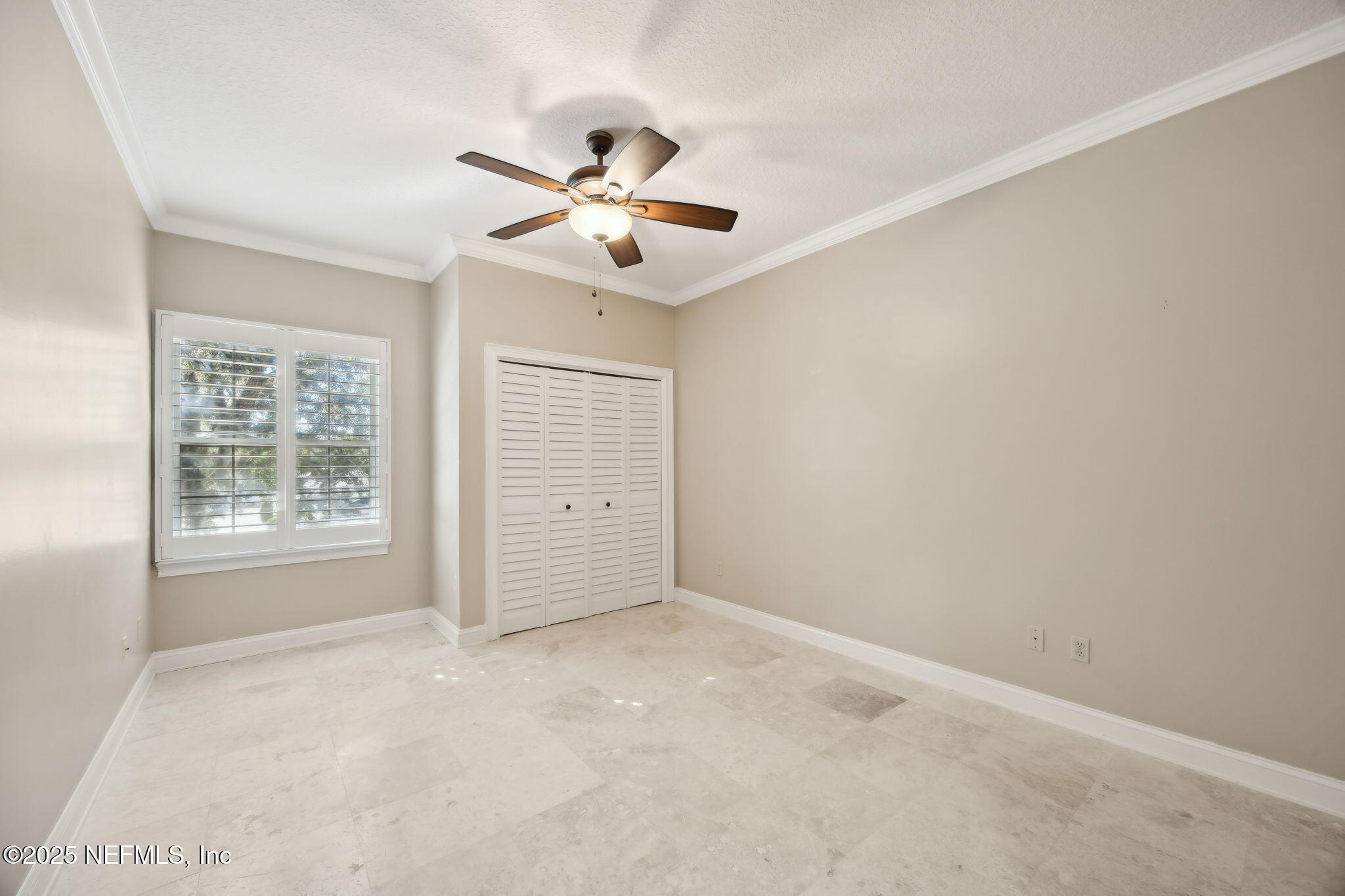 300 Bermuda Bay Circle, Unit 304 Ponte Vedra Beach, FL 32082 - Photo 28 of 42 an empty room with windows and fan