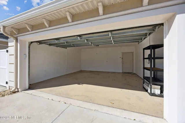 a front view of a house with plants