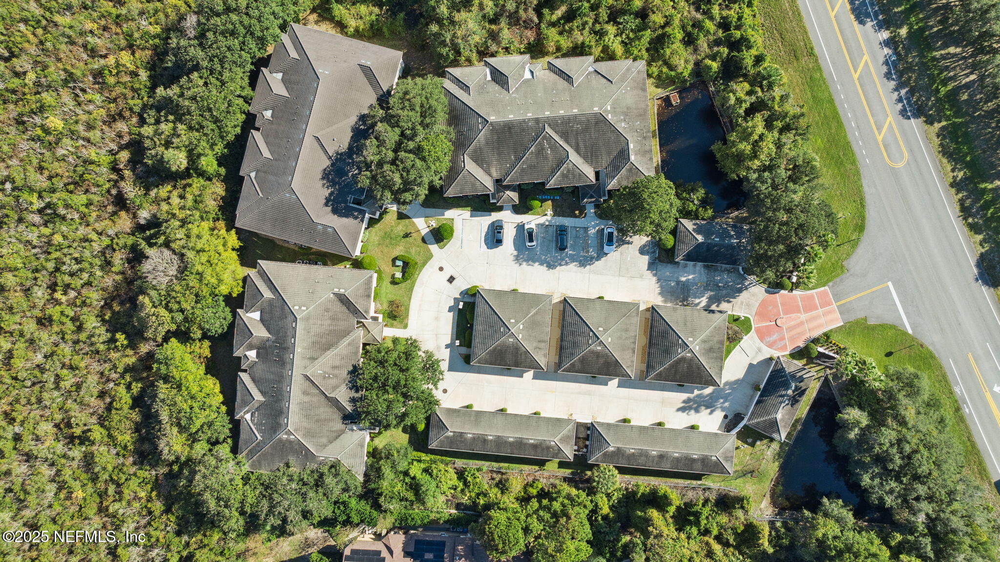 300 Bermuda Bay Circle, Unit 304 Ponte Vedra Beach, FL 32082 - Photo 42 of 42 an aerial view of a house with a yard and large trees