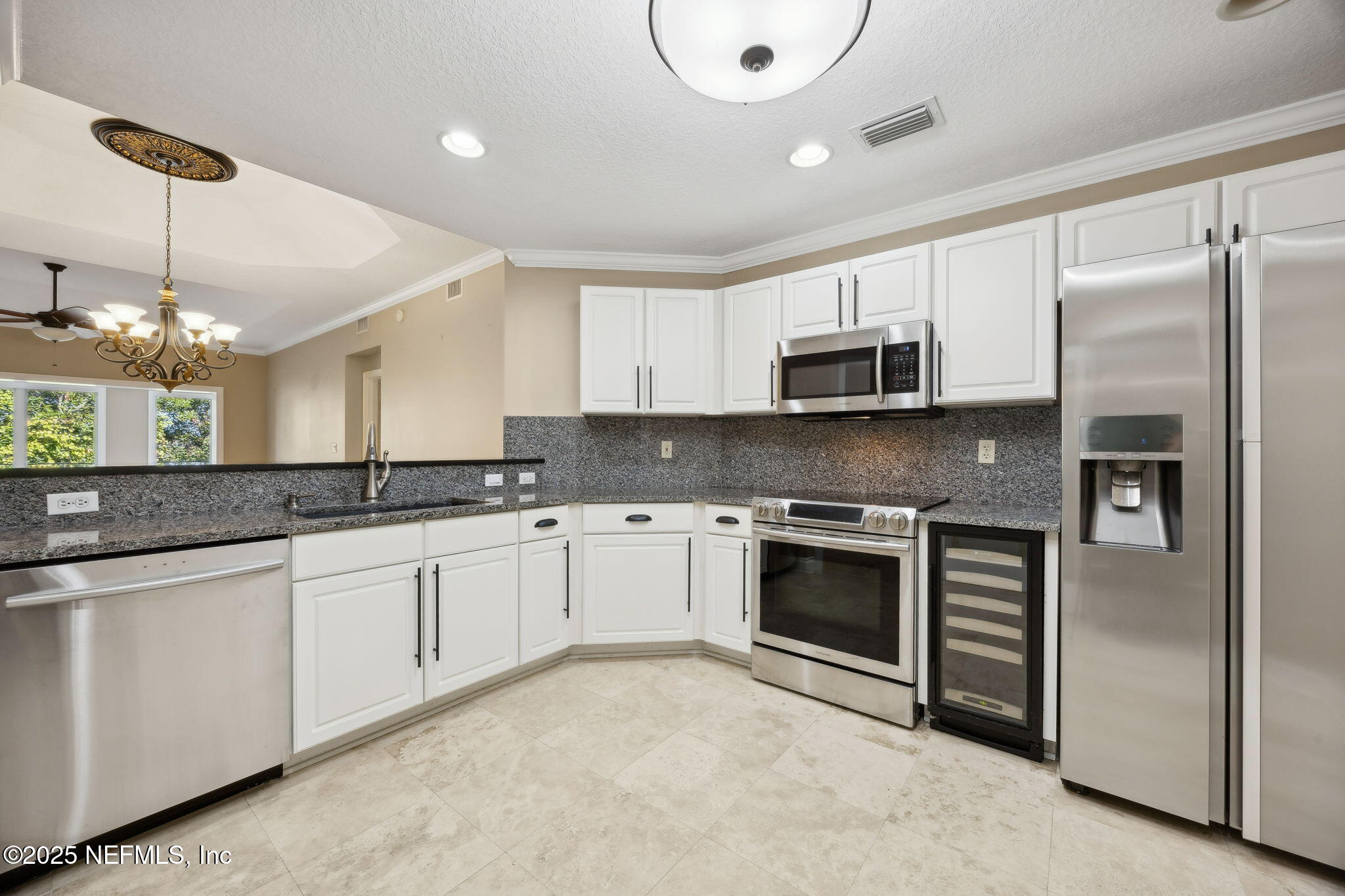 300 Bermuda Bay Circle, Unit 304 Ponte Vedra Beach, FL 32082 - Photo 7 of 42 a kitchen with stainless steel appliances granite countertop a stove top oven a refrigerator and a sink