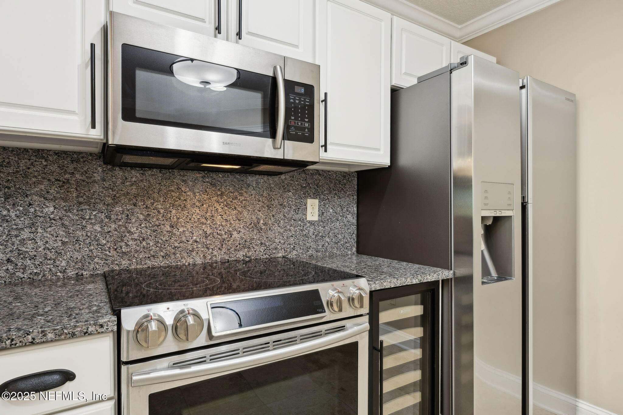 300 Bermuda Bay Circle, Unit 304 Ponte Vedra Beach, FL 32082 - Photo 9 of 42 a kitchen with granite countertop cabinets stainless steel appliances and a counter space