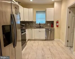 a kitchen with stainless steel appliances a refrigerator and a stove