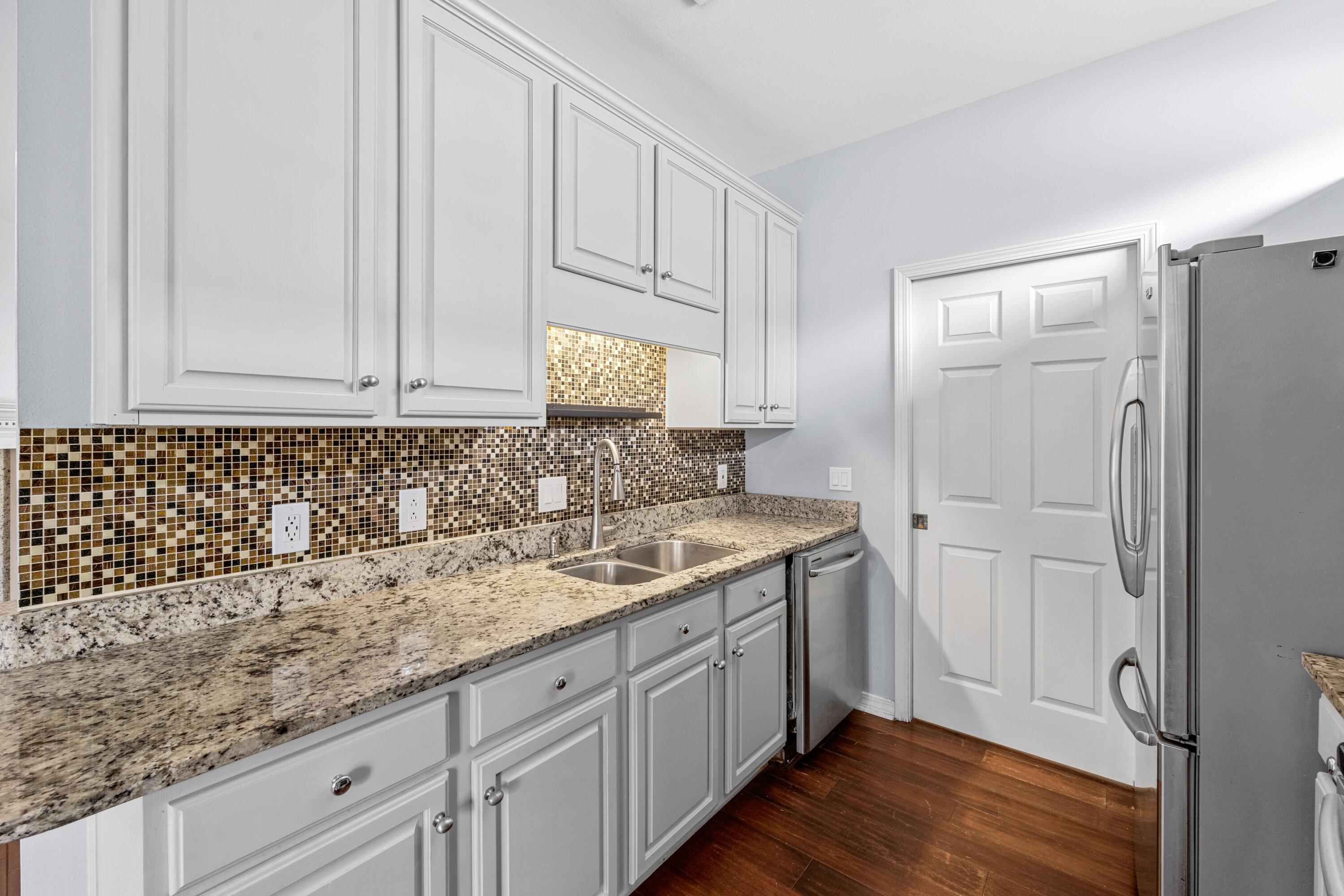 96 Trista Terrace Court Destin, FL 32541 - Photo 11 of 36 a kitchen with a sink and cabinets