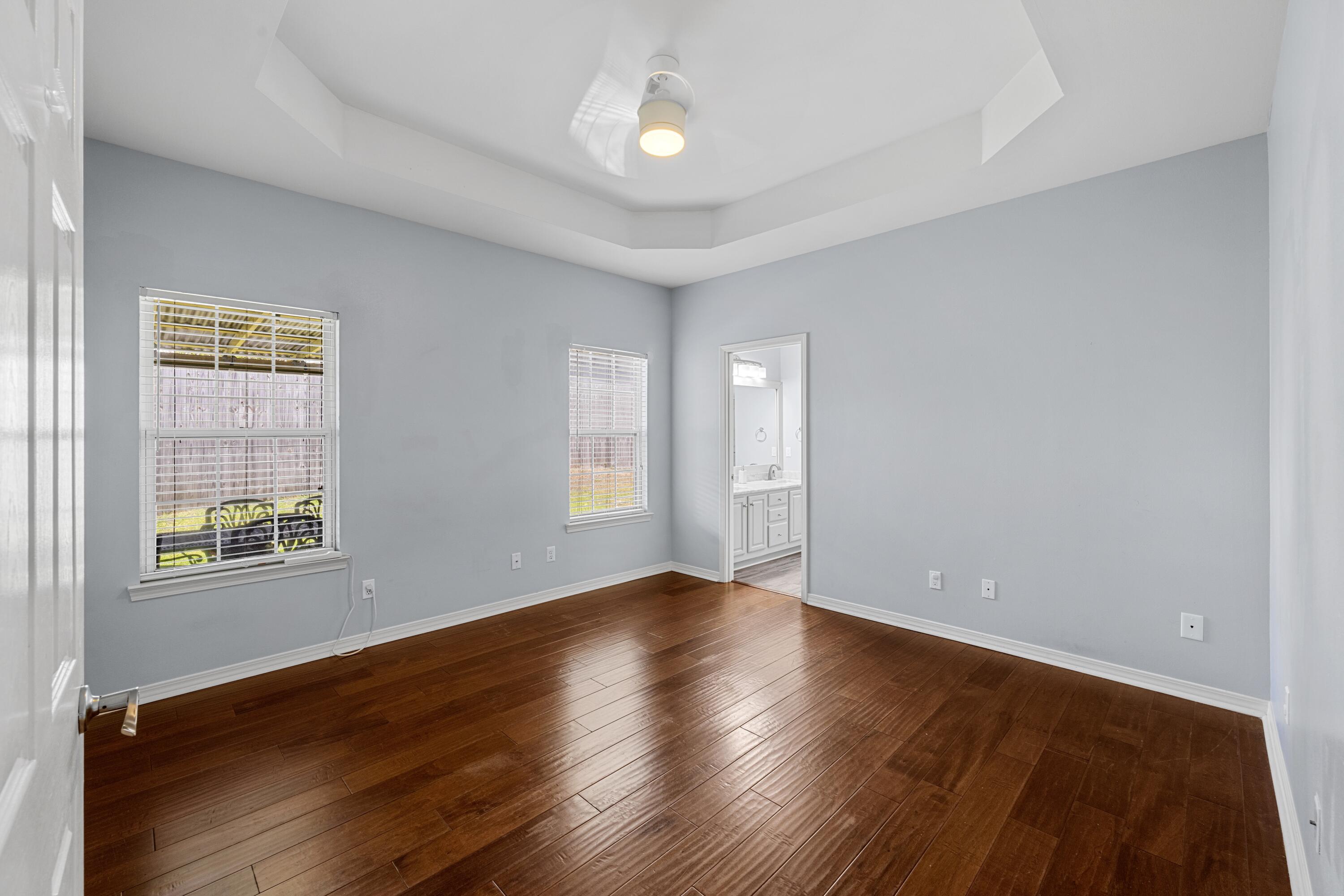 96 Trista Terrace Court Destin, FL 32541 - Photo 17 of 36 a view of an empty room with wooden floor and a window