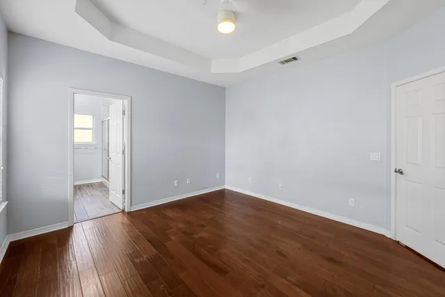 a view of a room with wooden floor and a window