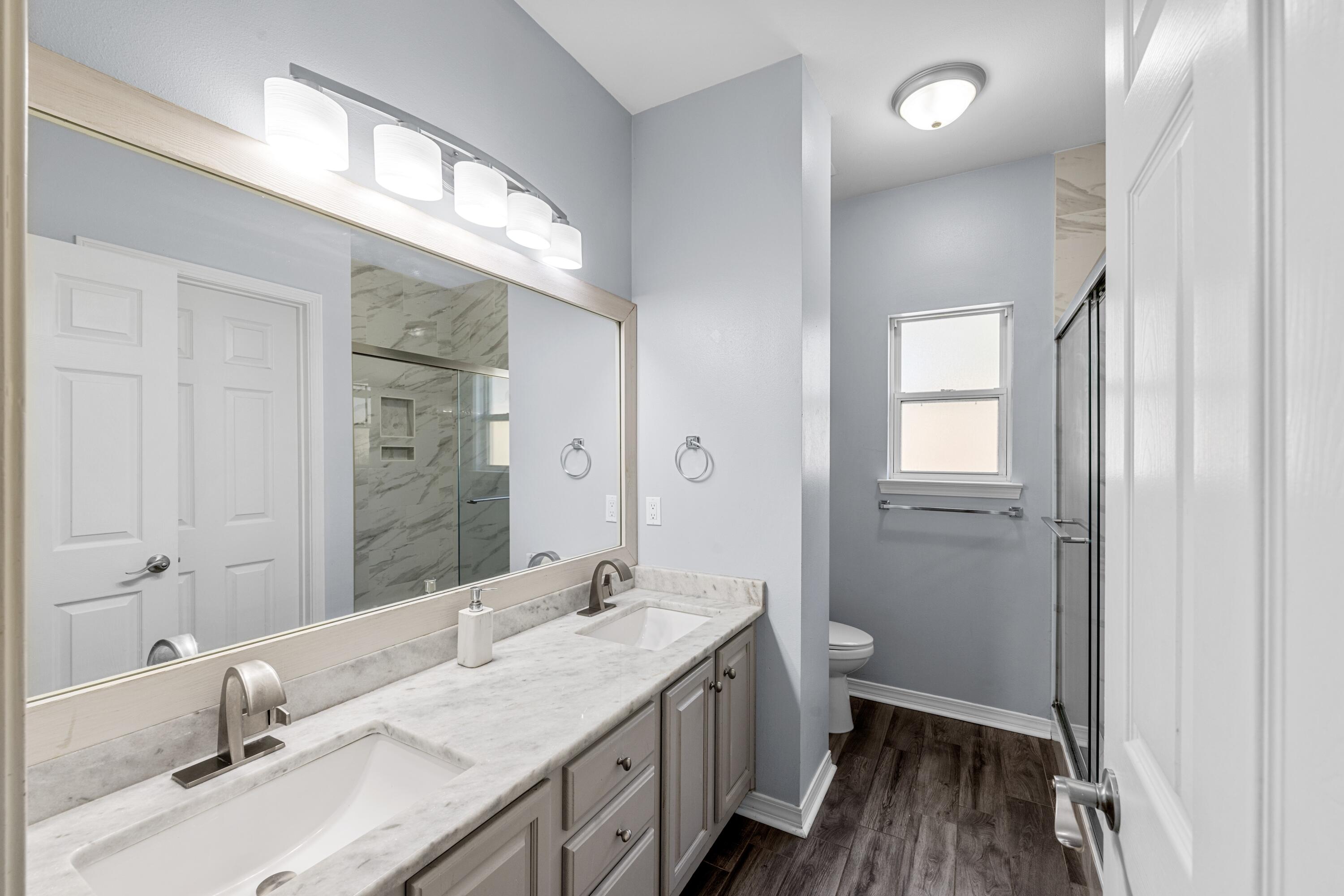 96 Trista Terrace Court Destin, FL 32541 - Photo 21 of 36 a bathroom with a granite countertop sink a mirror and a toilet