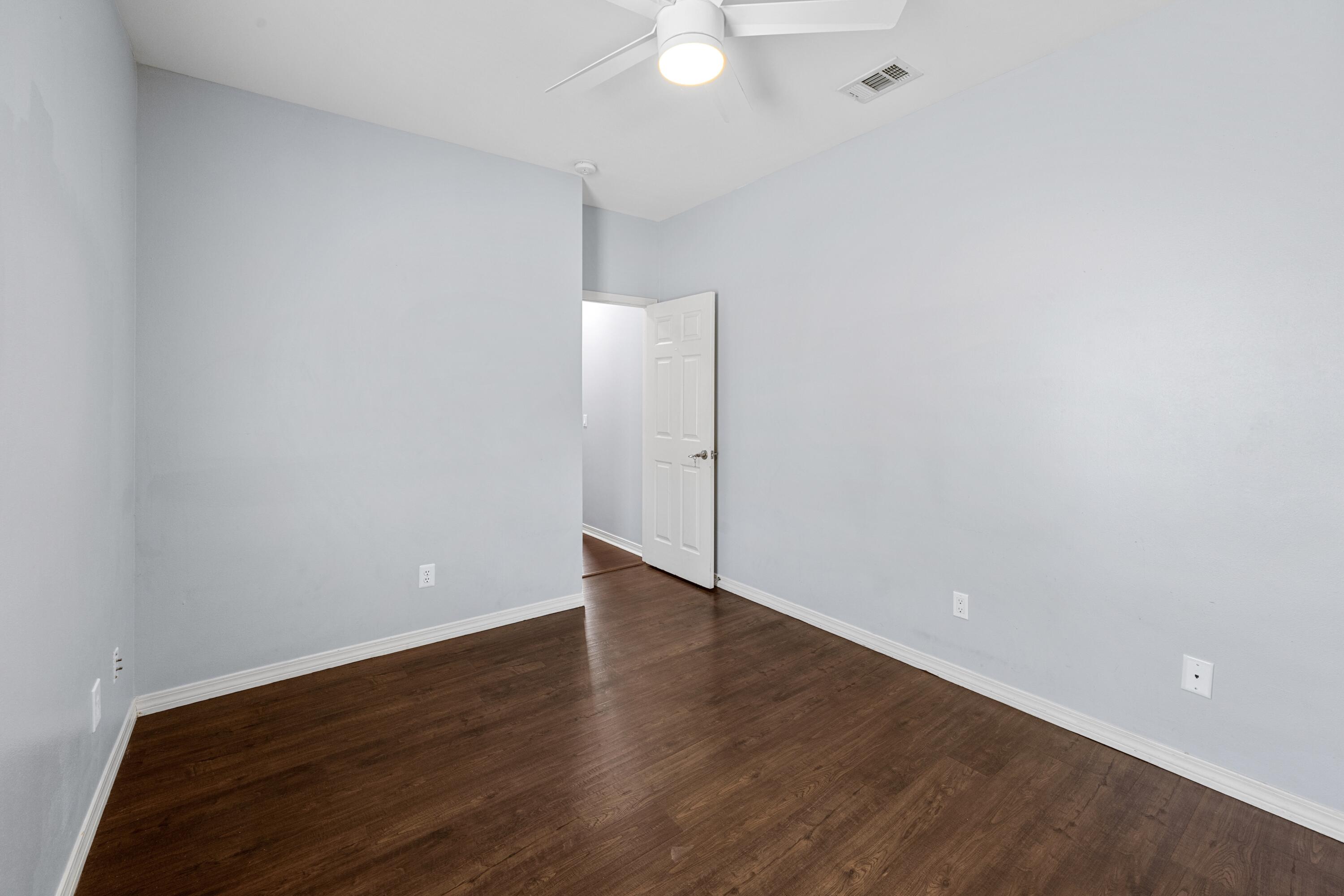 96 Trista Terrace Court Destin, FL 32541 - Photo 25 of 36 an empty room with wooden floor and white walls
