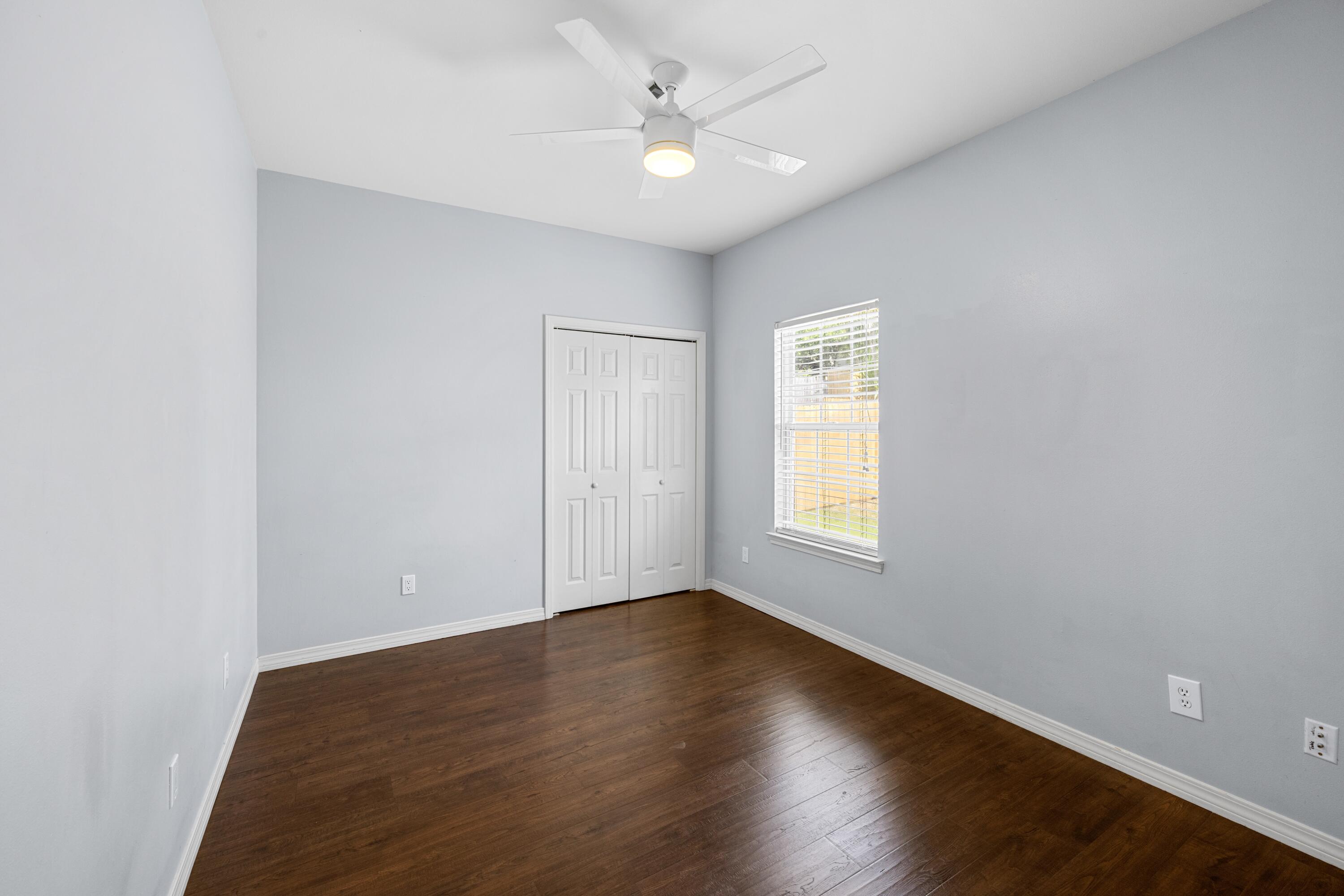 96 Trista Terrace Court Destin, FL 32541 - Photo 26 of 36 an empty room with wooden floor and windows