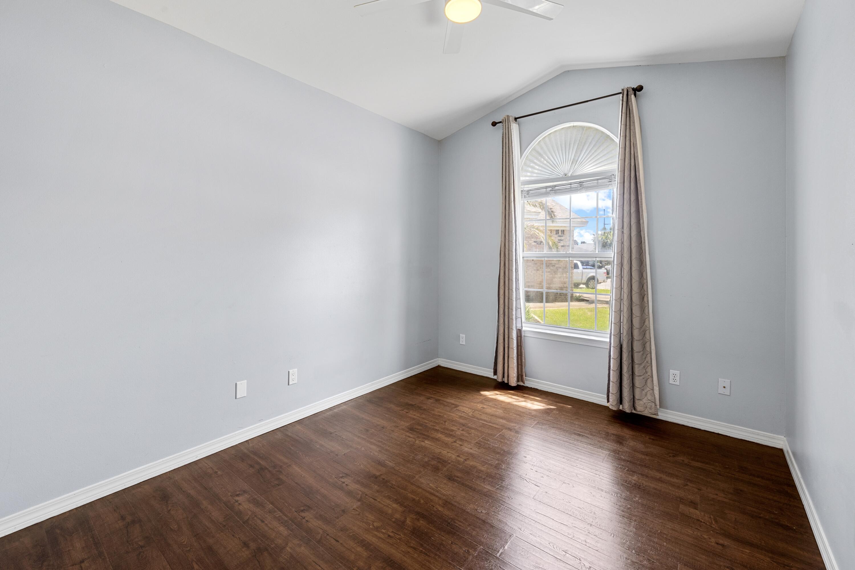 96 Trista Terrace Court Destin, FL 32541 - Photo 30 of 36 an empty room with wooden floor and windows