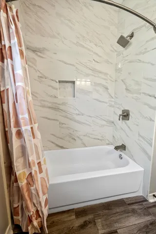 a view of a backyard with couches plants and large tree