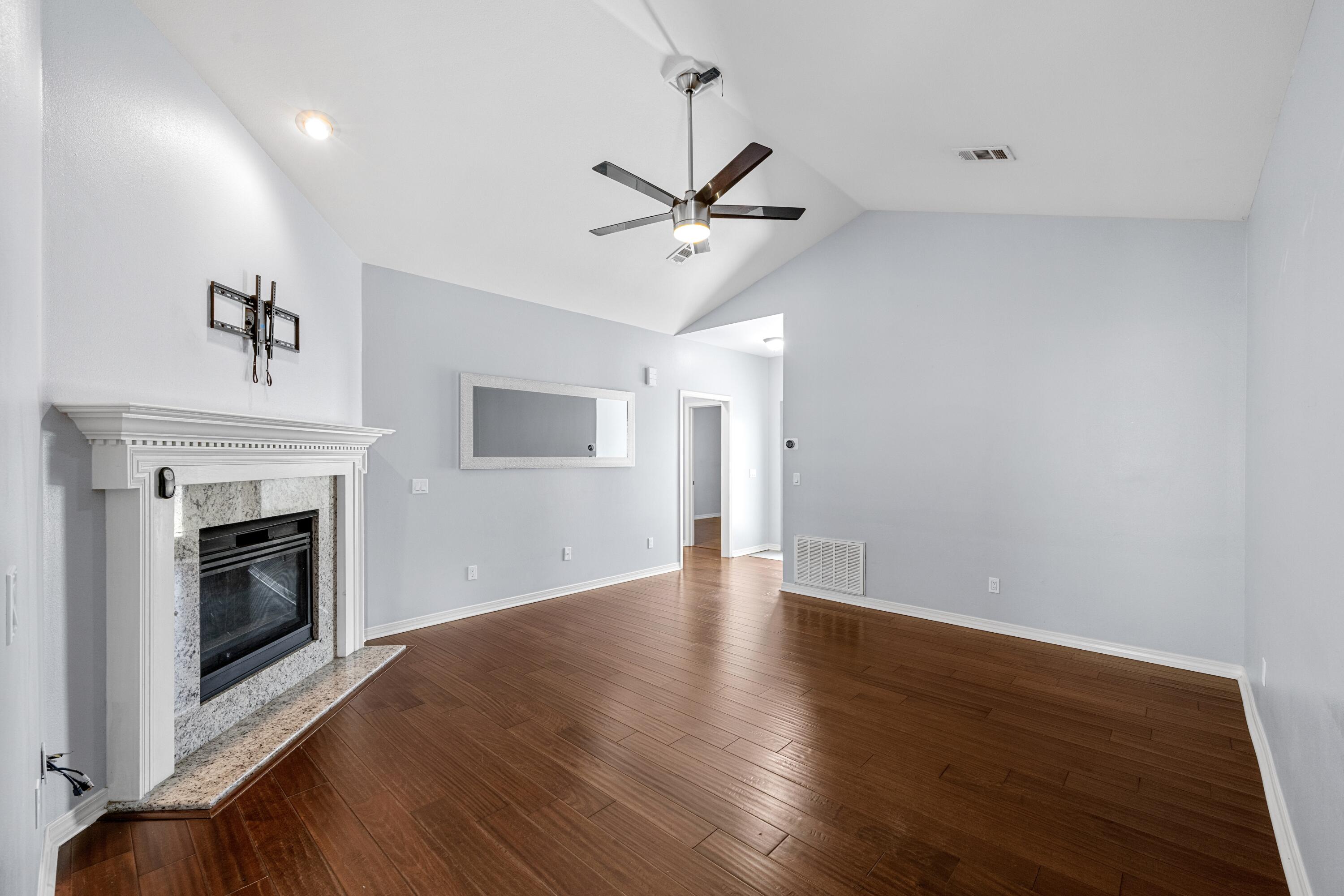 96 Trista Terrace Court Destin, FL 32541 - Photo 5 of 36 a view of a livingroom with a fireplace a ceiling fan and wooden floor