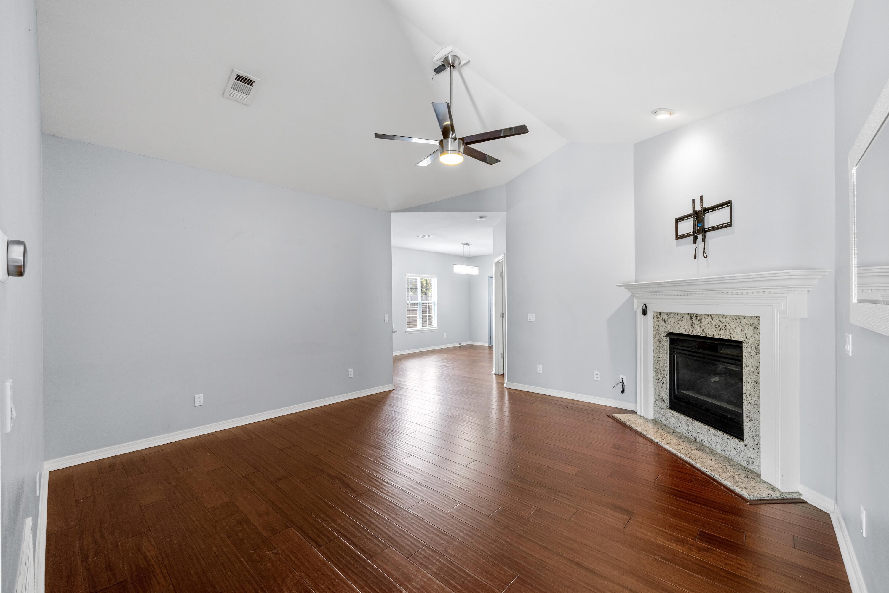 96 Trista Terrace Court Destin, FL 32541 - Photo 6 of 36 a view of an empty room with wooden floor fireplace and a window