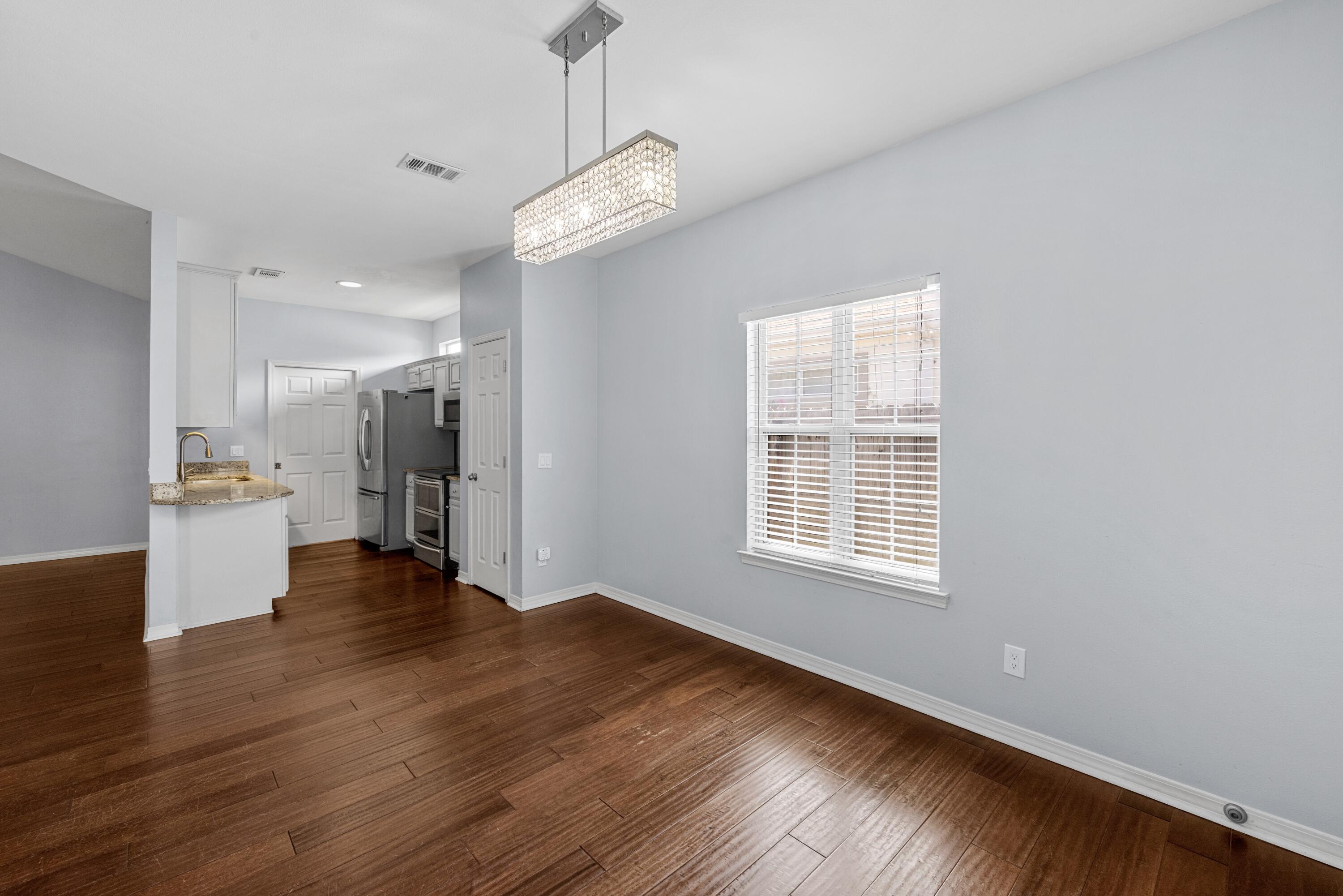 96 Trista Terrace Court Destin, FL 32541 - Photo 9 of 36 a view of an empty room with wooden floor and a window