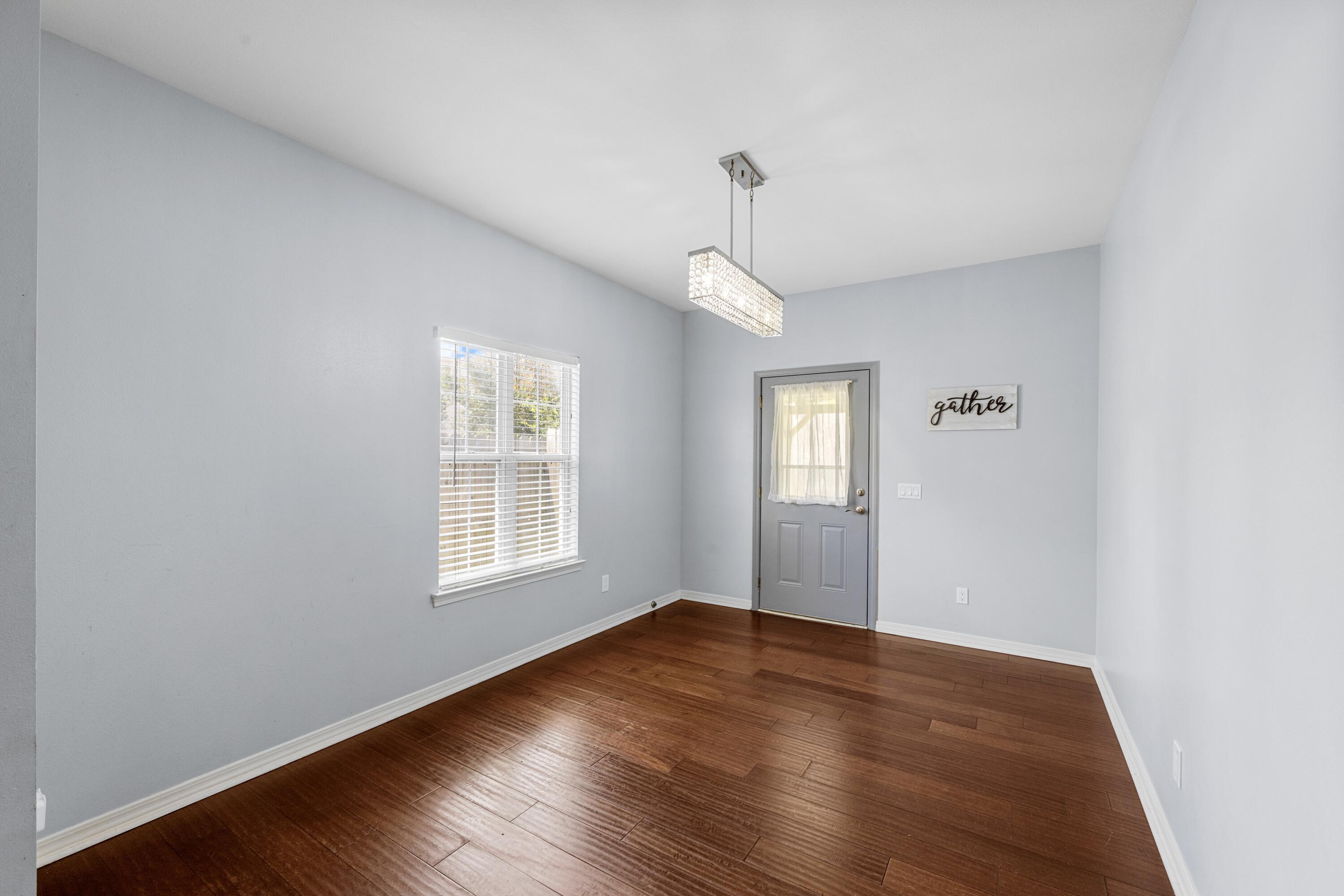96 Trista Terrace Court Destin, FL 32541 - Photo 10 of 36 a view of an empty room with wooden floor and a window