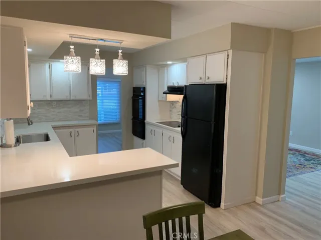 a kitchen with a refrigerator and a sink