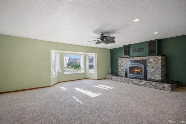a view of an empty room with a fireplace