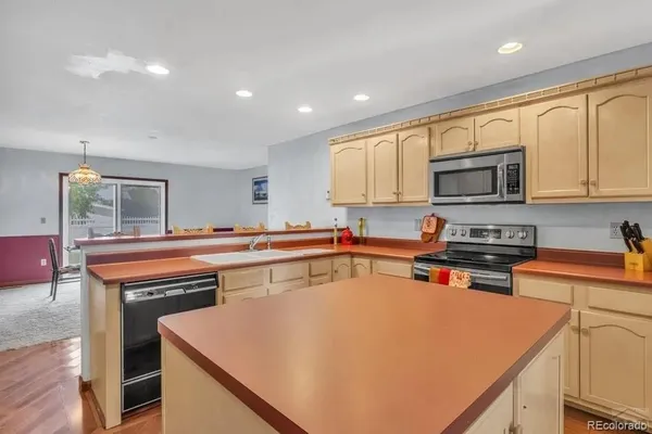 a kitchen with a stove a sink and a microwave