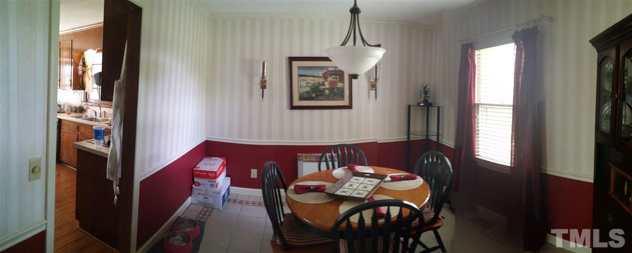 7000 Mitchell Mill Road Zebulon, NC 27597 - Photo 3 of 6 a view of a dining room with furniture and window