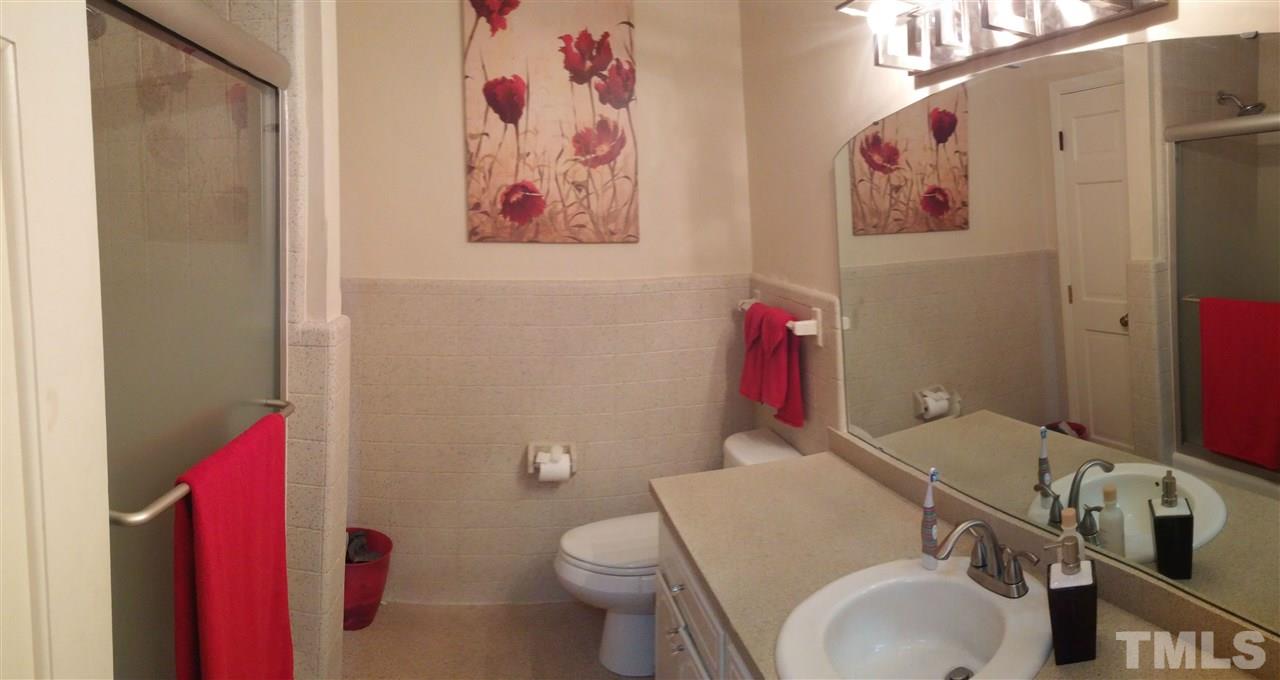 7000 Mitchell Mill Road Zebulon, NC 27597 - Photo 5 of 6 a bathroom with a sink mirror vanity and toilet