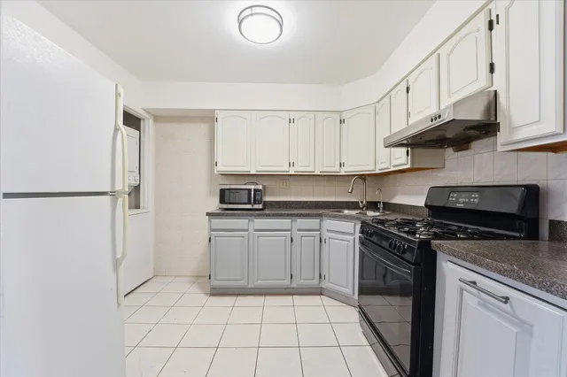 a kitchen with stainless steel appliances granite countertop a stove a refrigerator and a sink