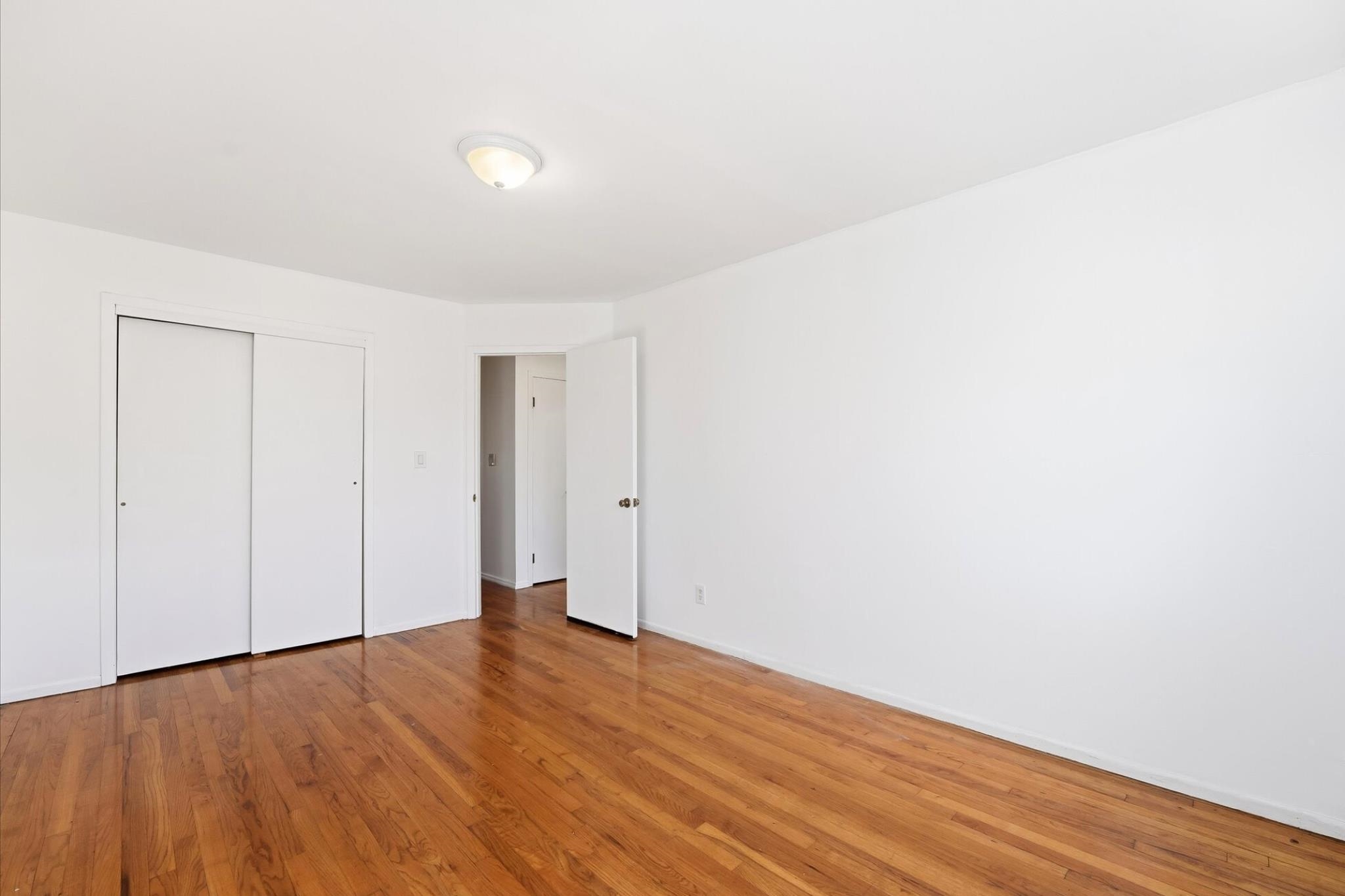 41 Alan Terrace, Unit 1 Jersey City, NJ 07306 - Photo 3 of 16 a view of an empty room with wooden floor
