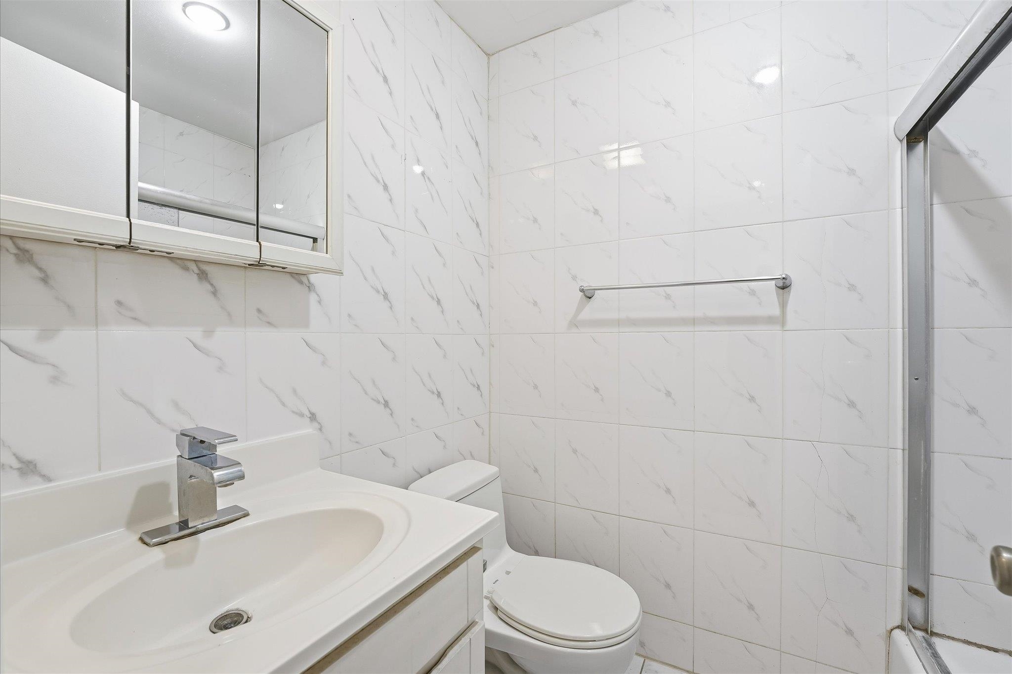 41 Alan Terrace, Unit 1 Jersey City, NJ 07306 - Photo 8 of 16 a bathroom with a sink a toilet and shower