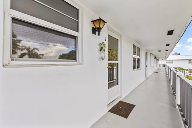 a view of a hallway with wooden floor and entryway