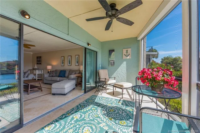 a living room with furniture and flowers
