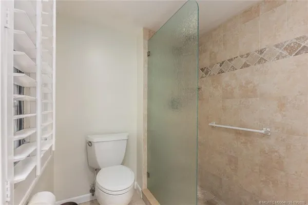a a bathroom with a toilet and a shower