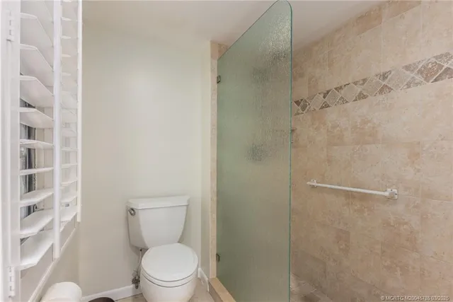 a a bathroom with a toilet and a shower