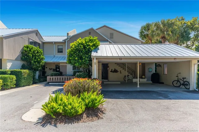 a front view of a house with a porch and furniture