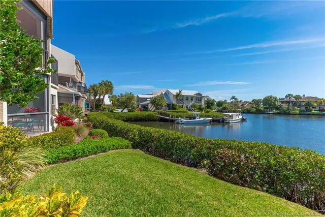 a view of a lake with houses in the back