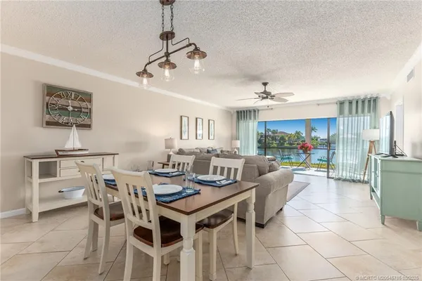 a view of a dining room with furniture and a chandelier