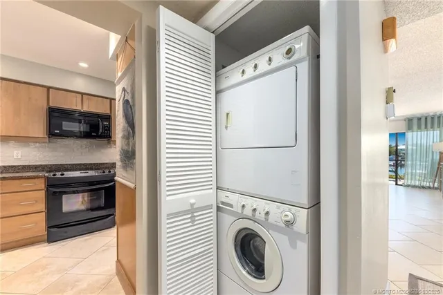 a view of kitchen with stainless steel appliances cabinets and a refrigerator