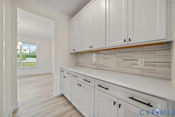 a kitchen with granite countertop white cabinets and sink