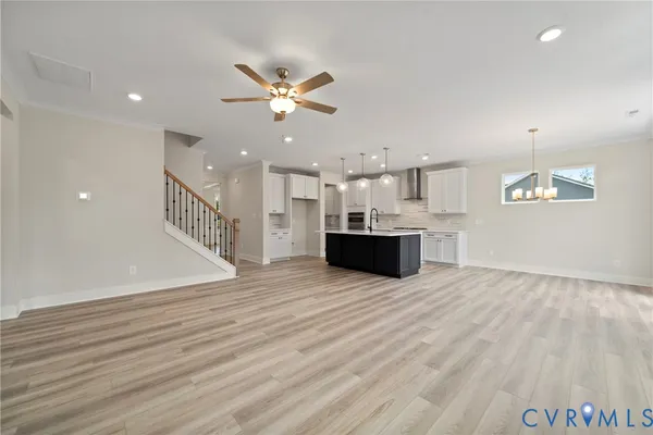 a view of a kitchen with a sink and wooden floor