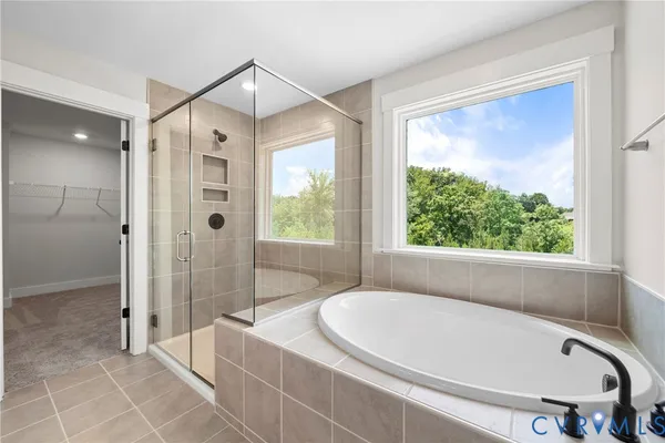 a bathroom with a bathtub and a shower