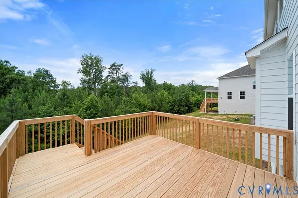 a balcony with wooden floor and fence