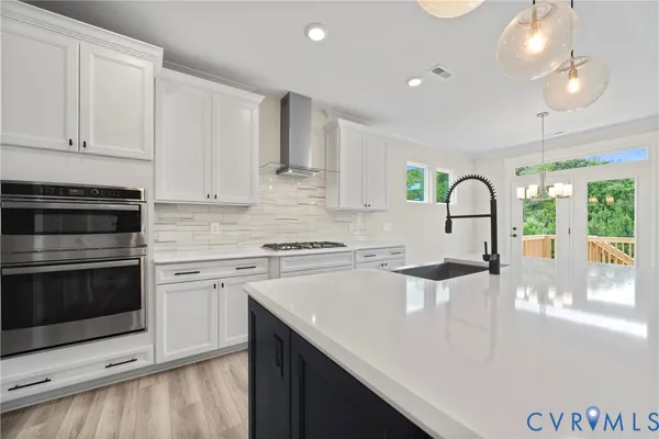 a kitchen with a sink a stove and cabinets