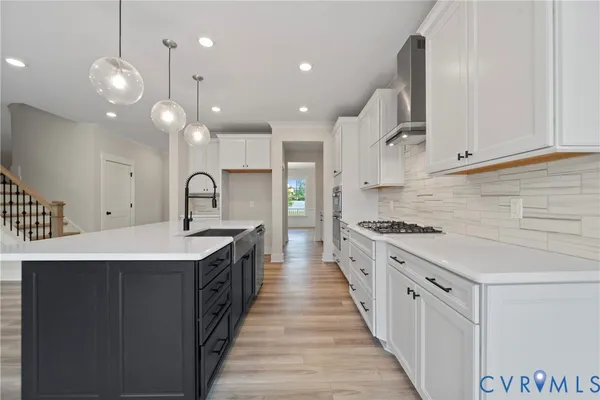a kitchen with stainless steel appliances a sink stove and cabinets