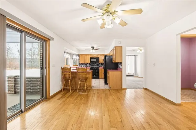 a view of a living room dining room and wooden floor