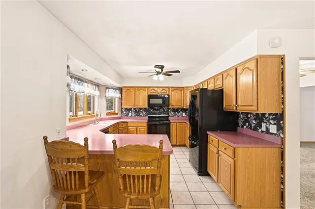 a kitchen with stainless steel appliances granite countertop a stove refrigerator and a sink
