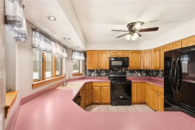a kitchen with a sink and large window