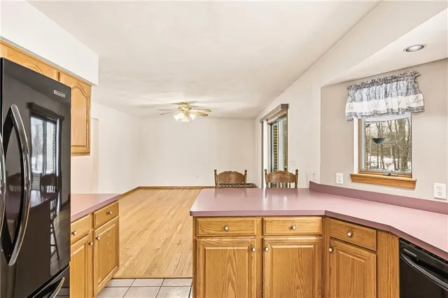 a view of a hallway with a white cabinet and a large mirror