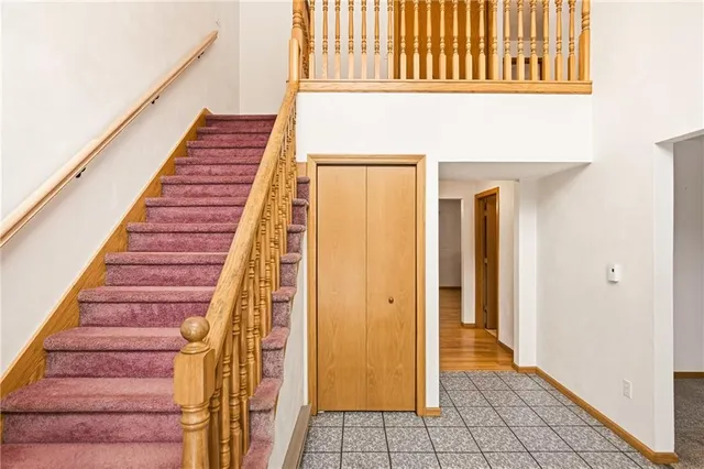 a view of staircase with railing