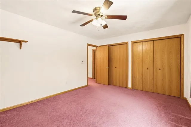 a spacious bathroom with a granite countertop sink a mirror and a shower