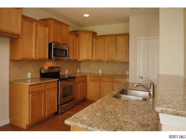 2187 Durand Road, Unit 83 Fort Mill, SC 29715 - Photo 4 of 16 a kitchen with stainless steel appliances granite countertop a sink a stove and cabinets