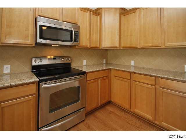 2187 Durand Road, Unit 83 Fort Mill, SC 29715 - Photo 5 of 16 a kitchen with stainless steel appliances granite countertop a stove microwave and sink