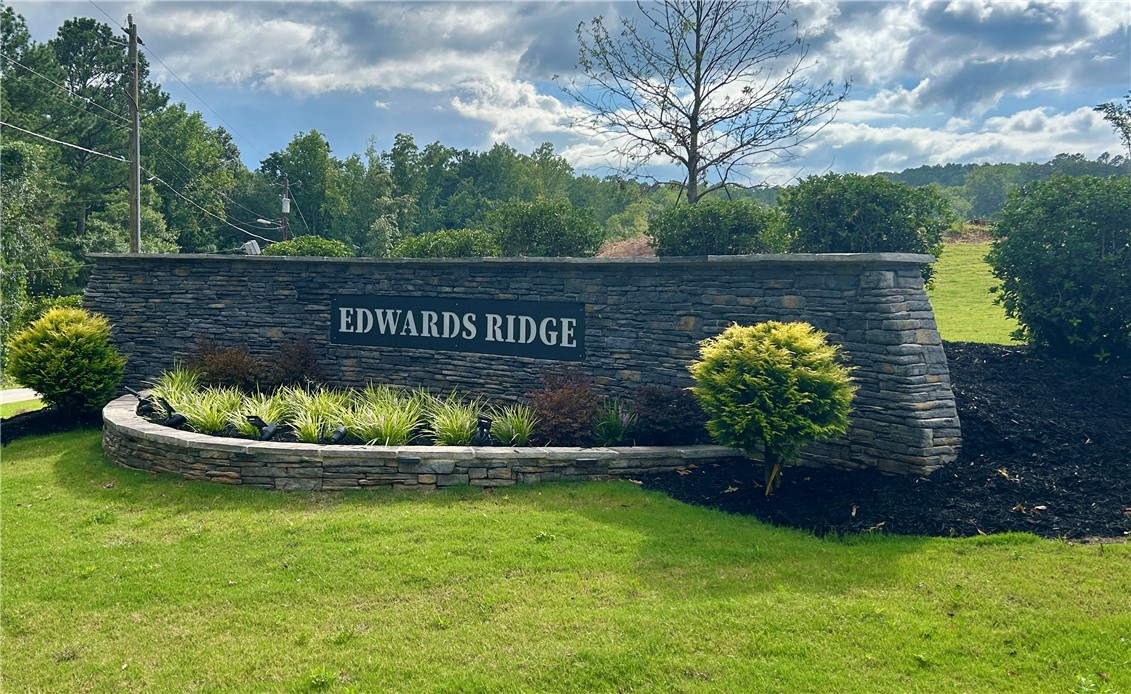 131 Shale Drive Central, SC 29630 - Photo 9 of 9 Welcome to Edwards Ridge, a beautifully landscaped entrance with natural stone and lush greenery.